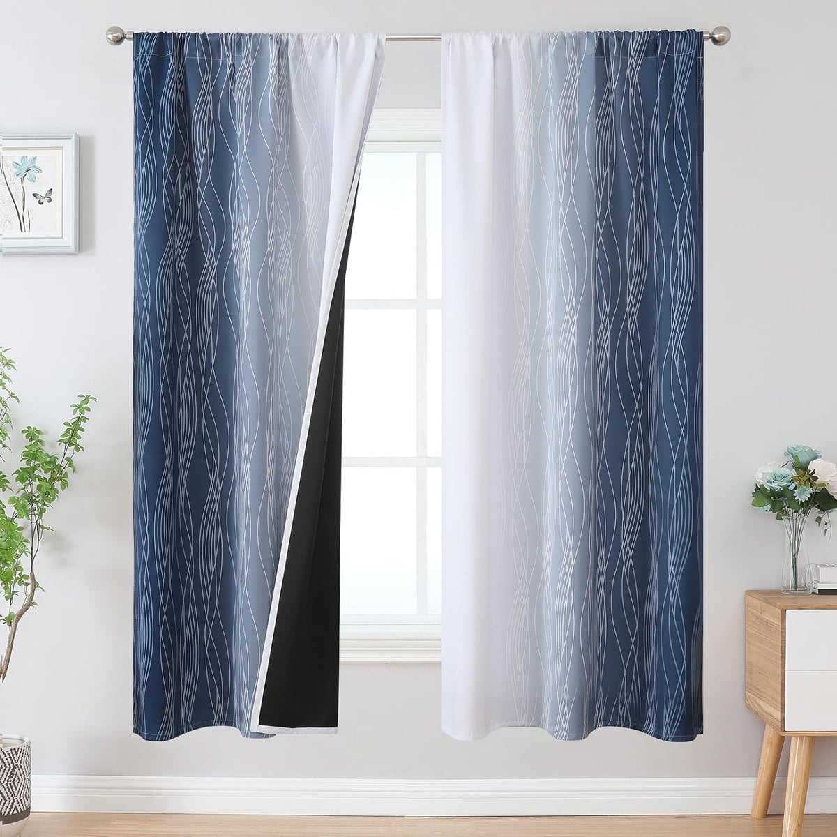Full-length view of blue-to-white ombre curtain panels hung on a rod with one panel slightly pulled back