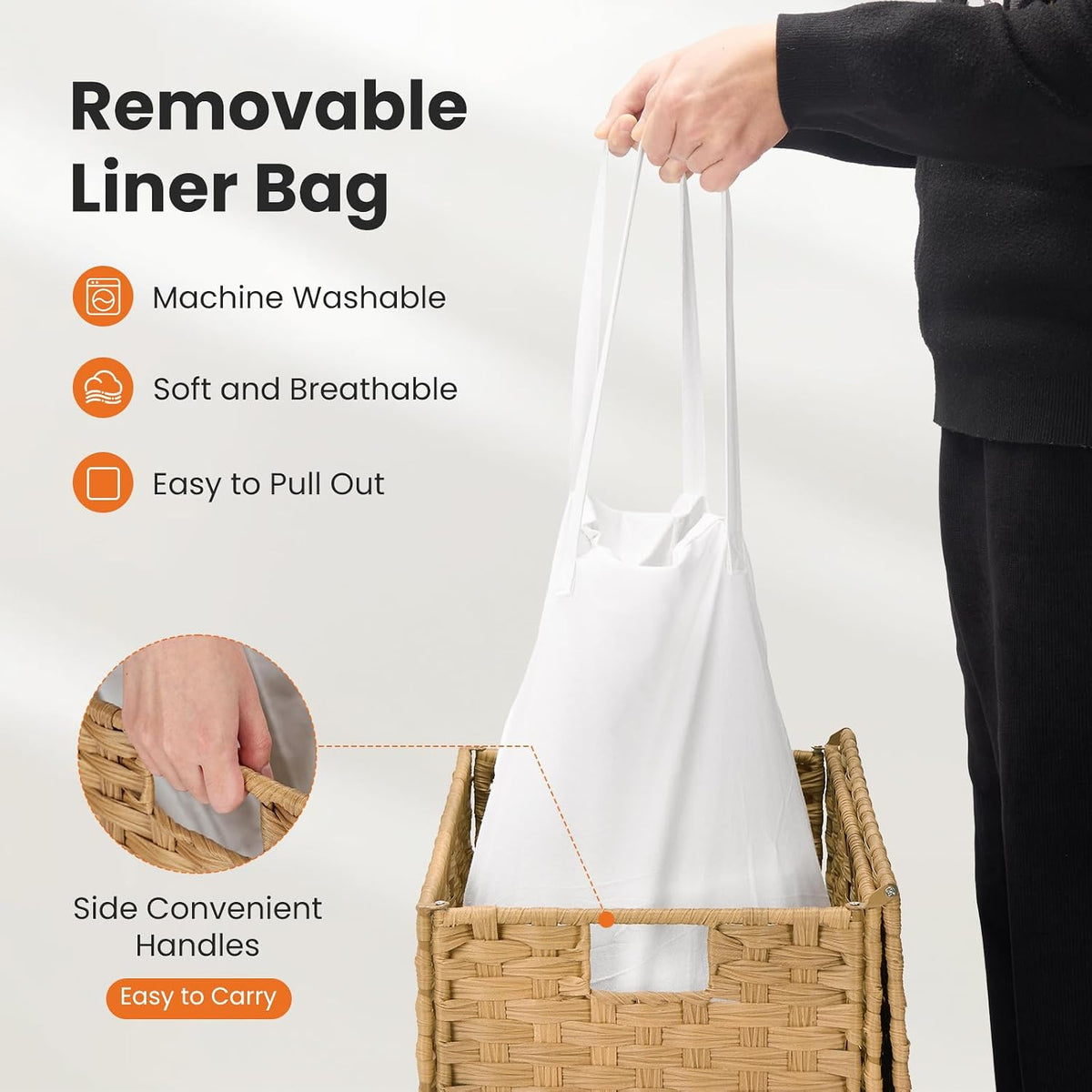 Person holding the removable white fabric liner straps above a woven laundry hamper