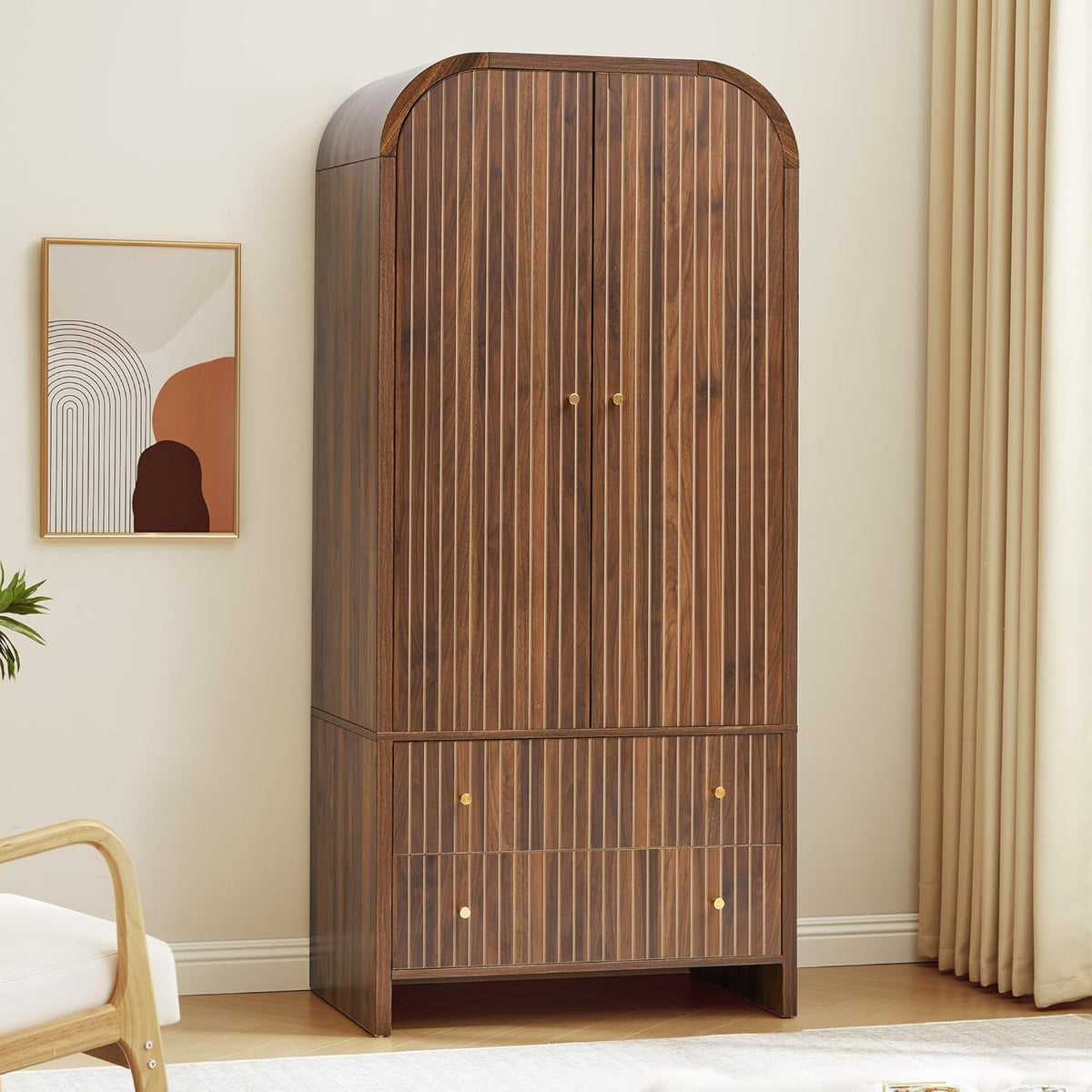 Walnut-finish armoire with arched top and vertical fluted doors, angled front view in a staged room