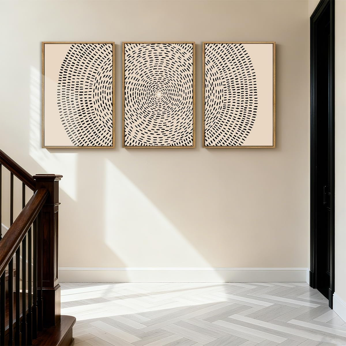 Set of three wood-framed beige canvas prints with black concentric dash design shown in a stairwell setting