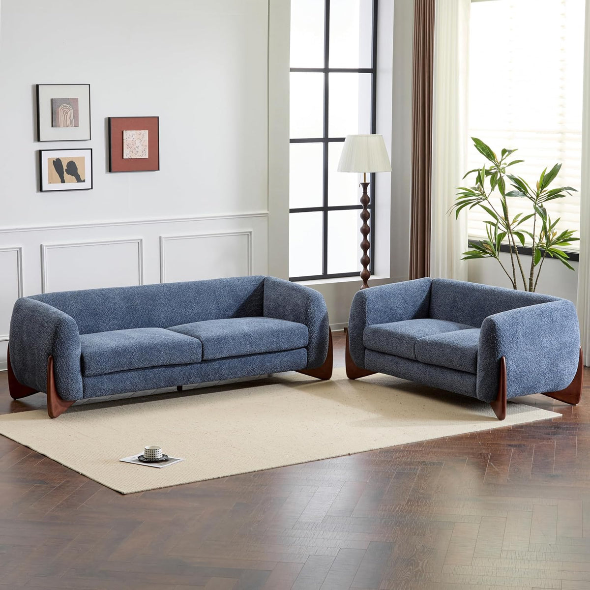 Bright room with blue upholstered three-seater sofa and matching loveseat