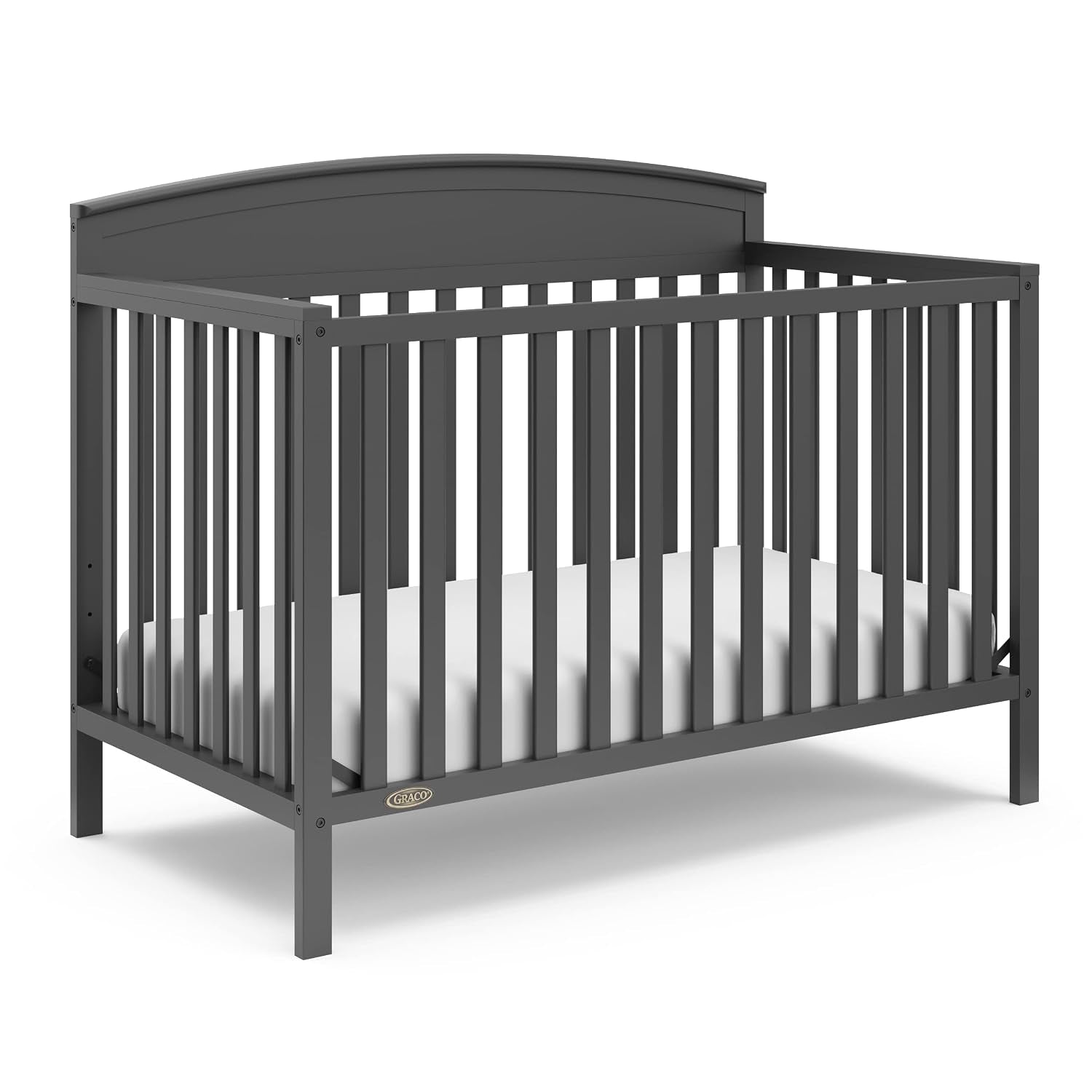 Front three-quarter view of a dark gray convertible crib with mattress in place and slatted sides.