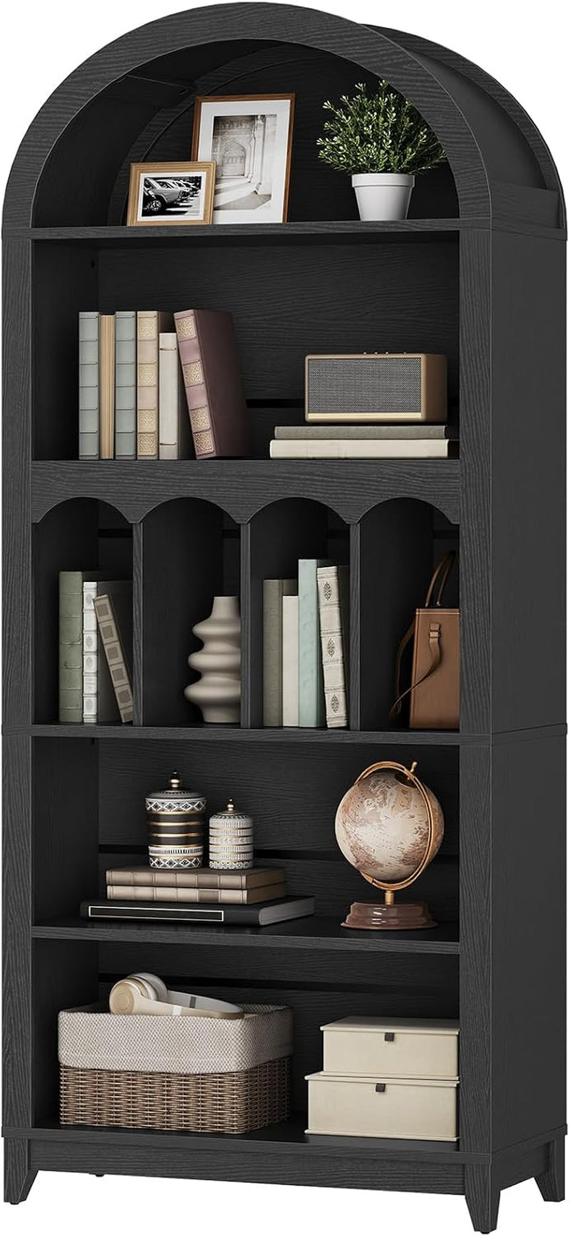 Studio front close-up of black arched bookcase showing arched top, vertical arched dividers, a globe and a woven basket.