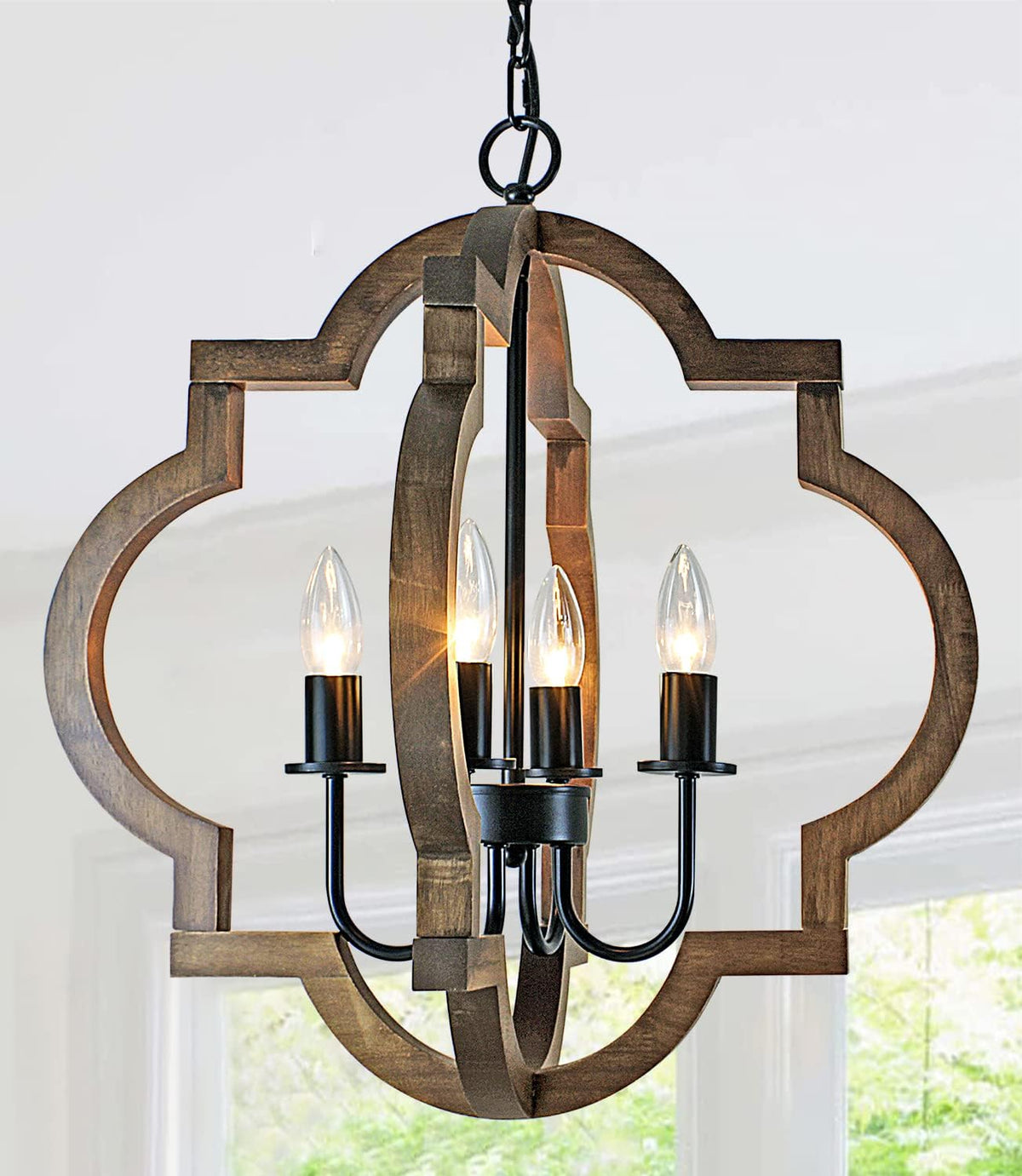Tight crop of the wood frame's layered profile and visible candle sockets with glowing bulbs.