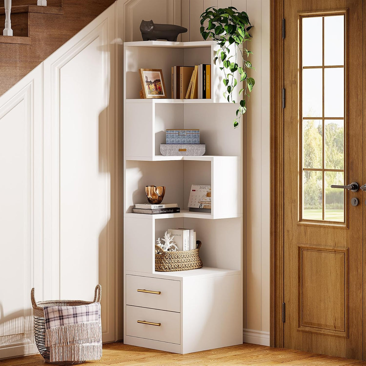 Full white L-shaped corner bookshelf staged by an entry door with books, baskets and a plant.