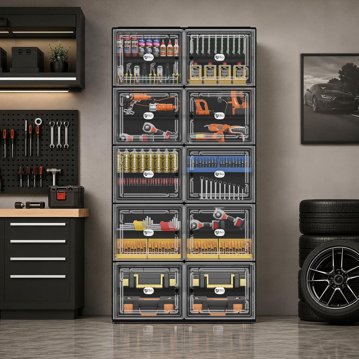 Modular clear-front storage units used as a tool organizer in a garage setting, with tools and stacked tires nearby.