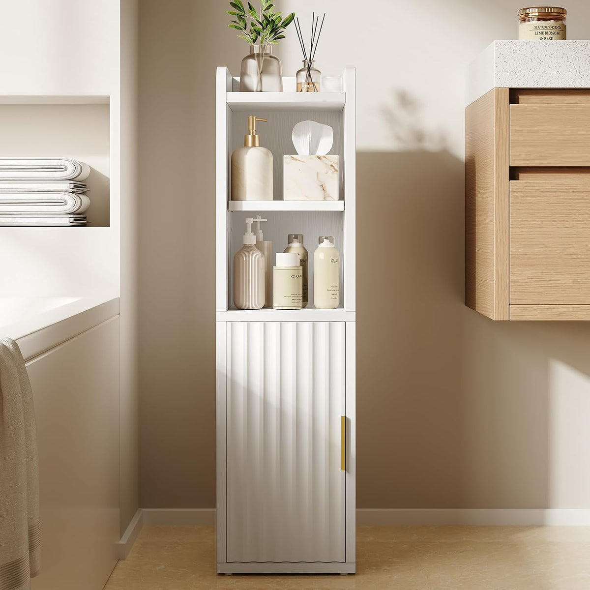 White slim freestanding bathroom cabinet front view with fluted lower door and open shelves styled with toiletries