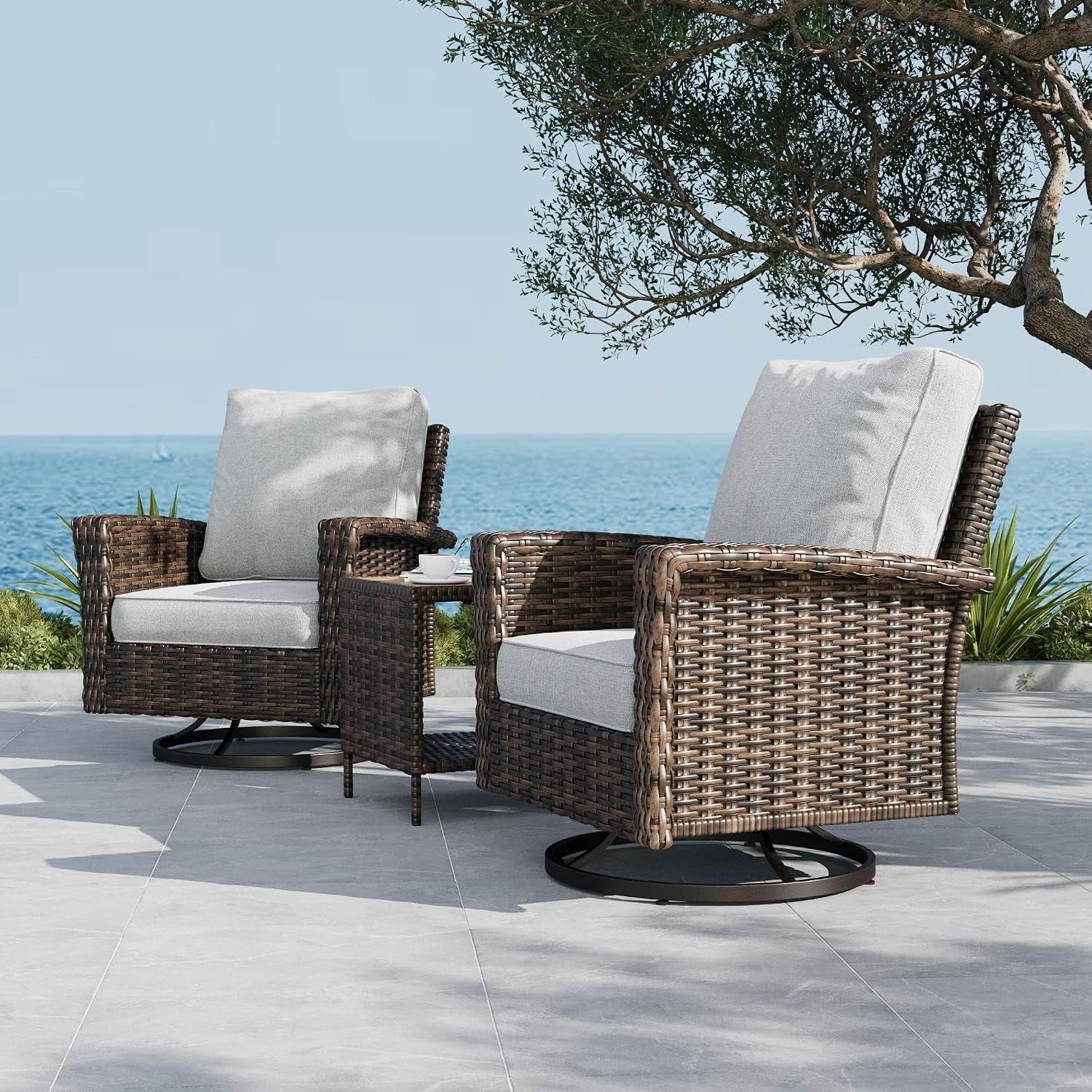Close side view of two wicker swivel chairs with light gray cushions and a narrow side table between them.