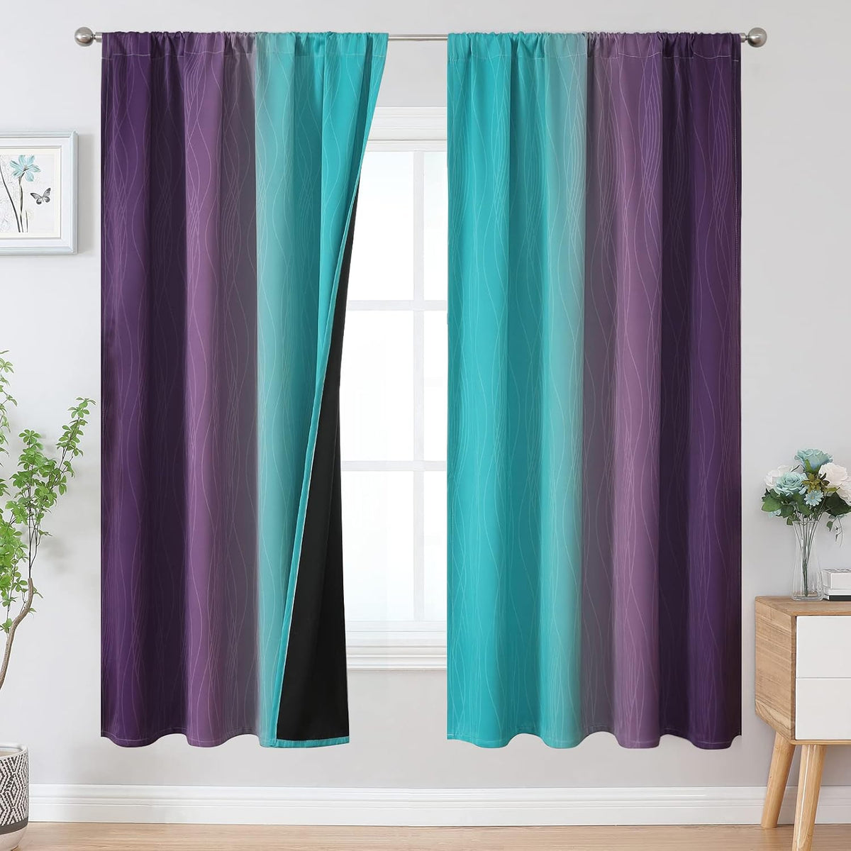 Window with two ombre curtains in turquoise to purple gradient, one panel pulled to show black backing