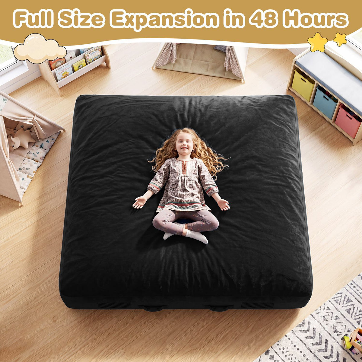Child sitting on a large black crash pad in a bright playroom, viewed from above.