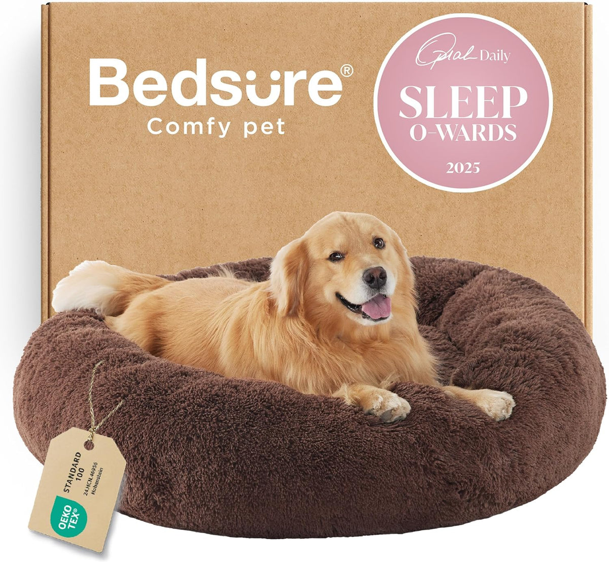 Golden retriever lying in a brown fluffy donut bed placed in front of a cardboard box backdrop.
