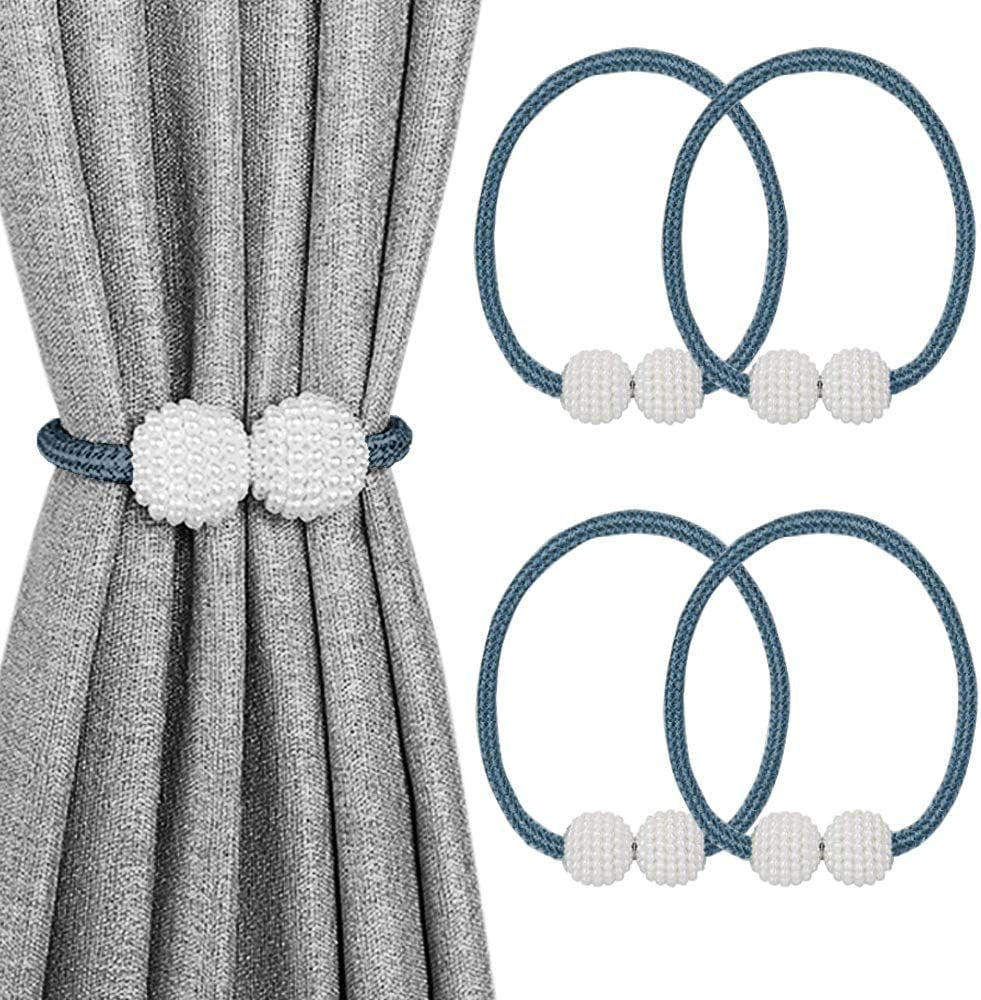 Gray curtain held by a dark blue braided tieback with two textured white pearl-like balls.