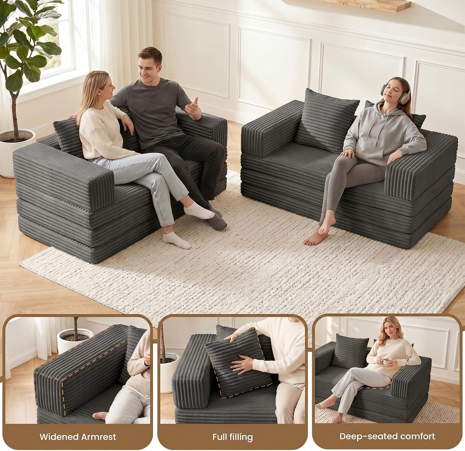 Two people seated on separate dark grey boneless sofas demonstrating seating arrangement and scale in a living room