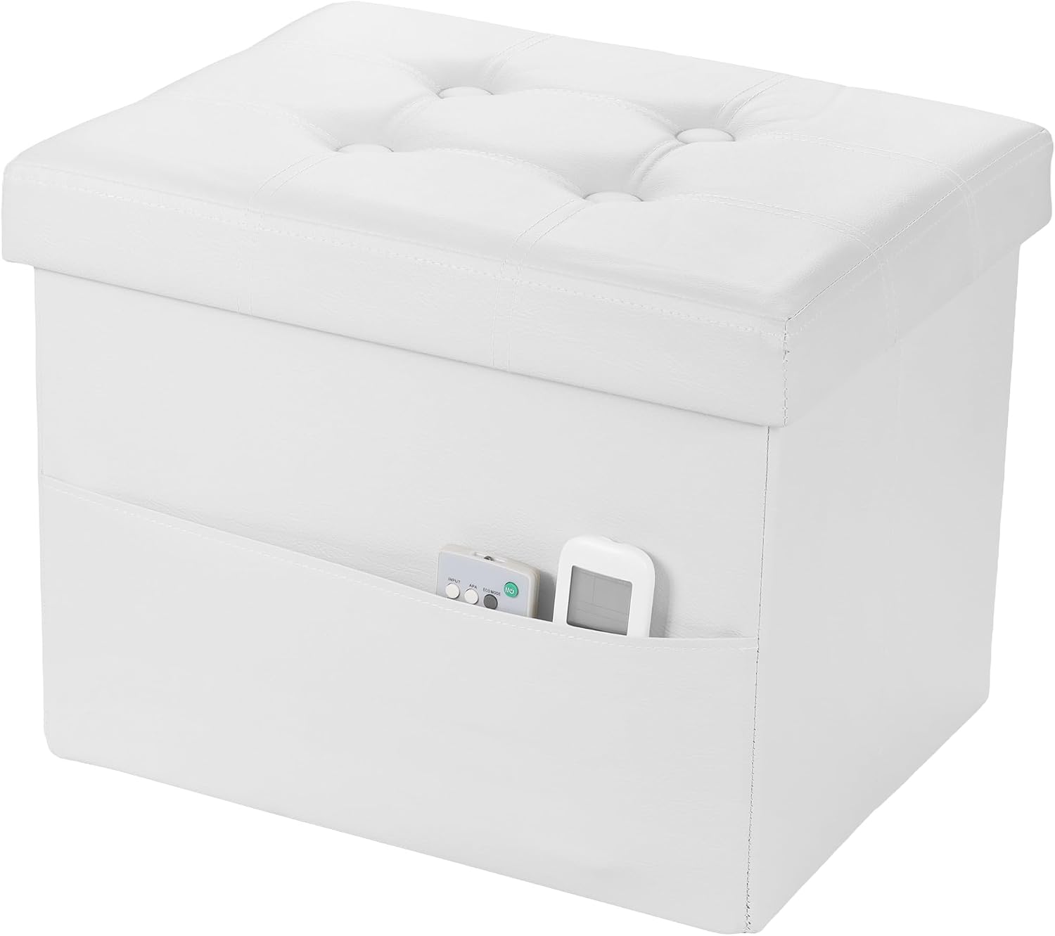 White tufted faux-leather storage ottoman shown closed with side pocket holding remotes.