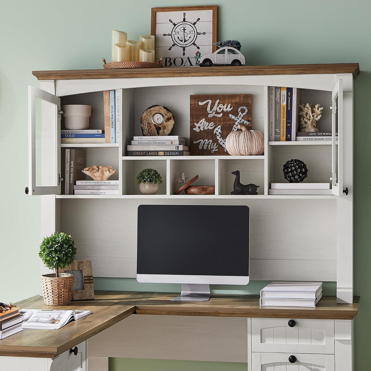 Close-up of the 42 in hutch showing glass-front cabinets, open cubbies and display shelving in antique white finish