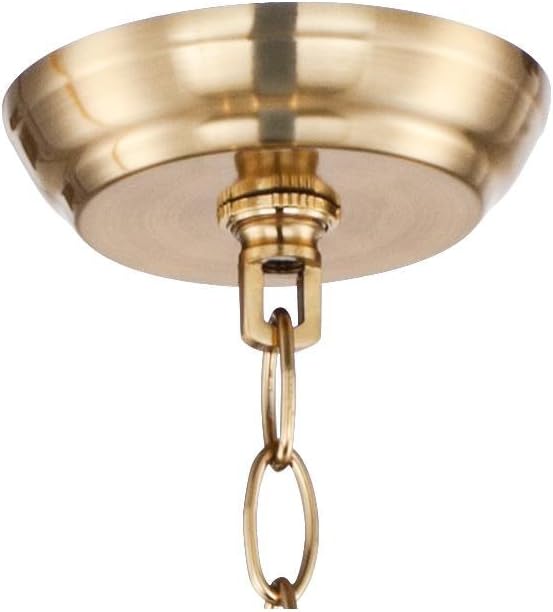 Tight crop of the ceiling canopy and first chain links in a polished warm brass finish.