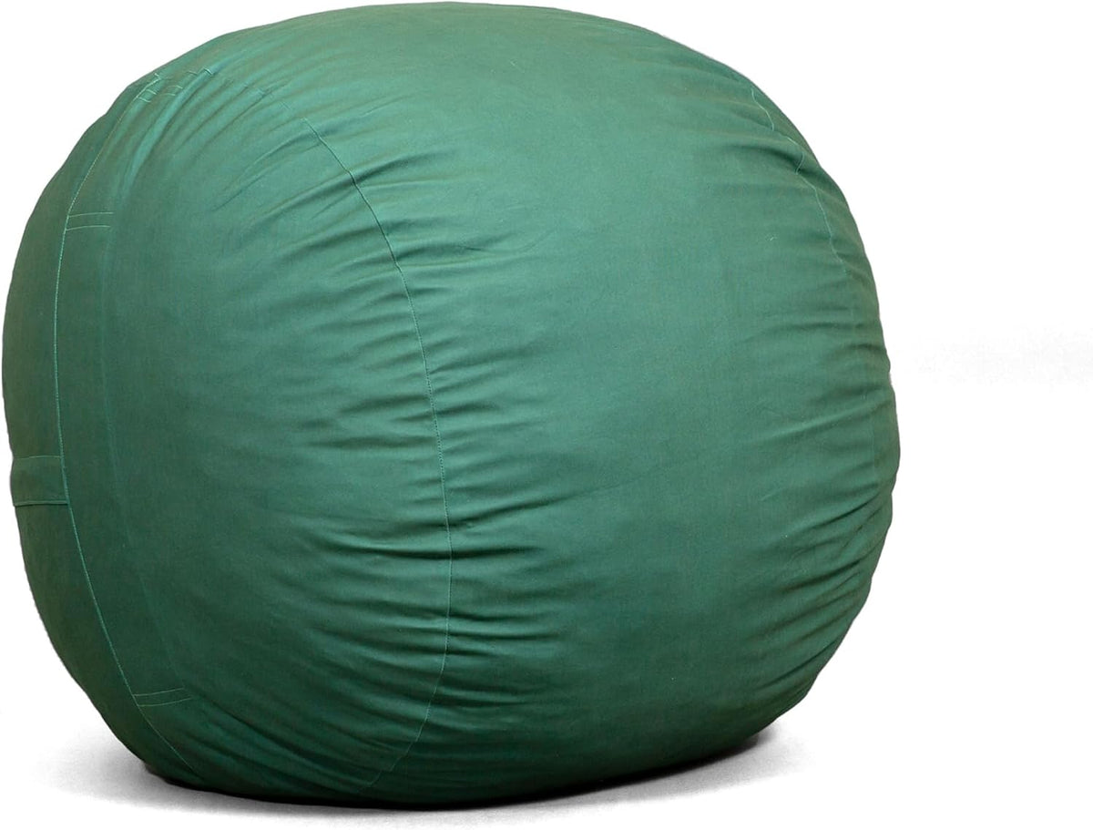 Close-up side view of a round oversized lounger in deep green fabric showing curved seams and slight surface wrinkles.