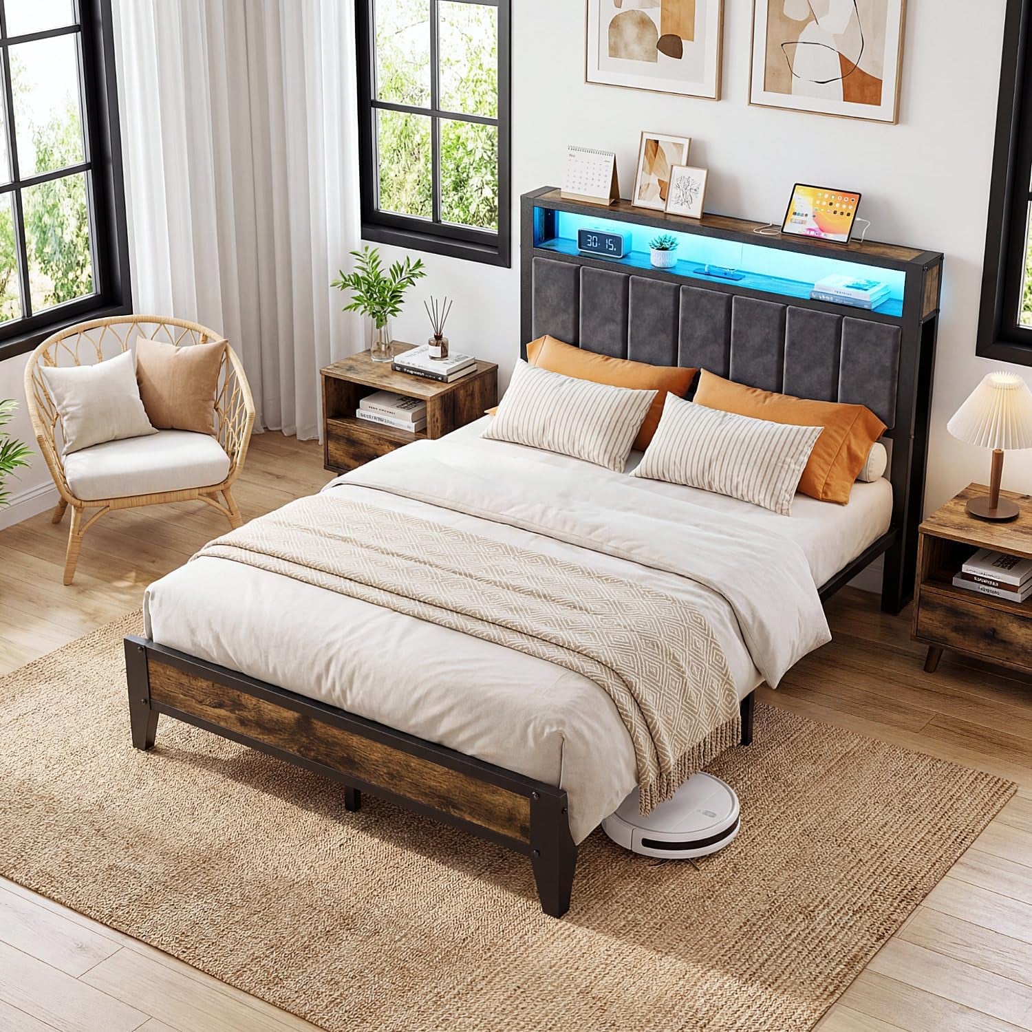 Aerial angled view of the bed in a bright corner room with chair, nightstand and blue LED light in the headboard shelf.