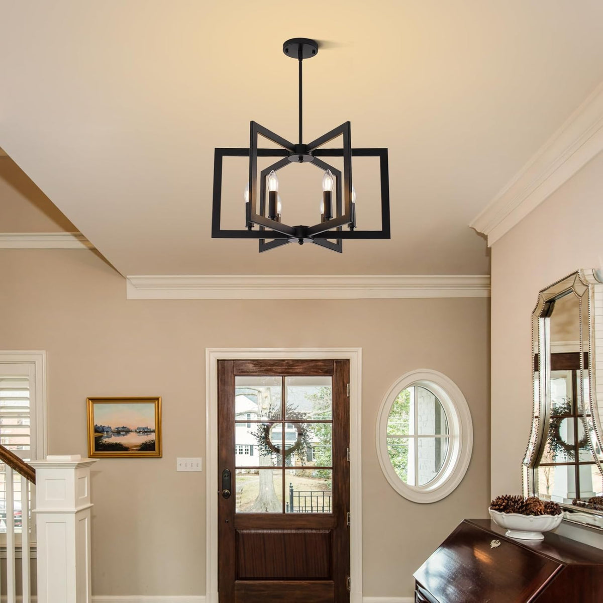 Black geometric six-light chandelier suspended in a foyer above a wooden front door and mirror.