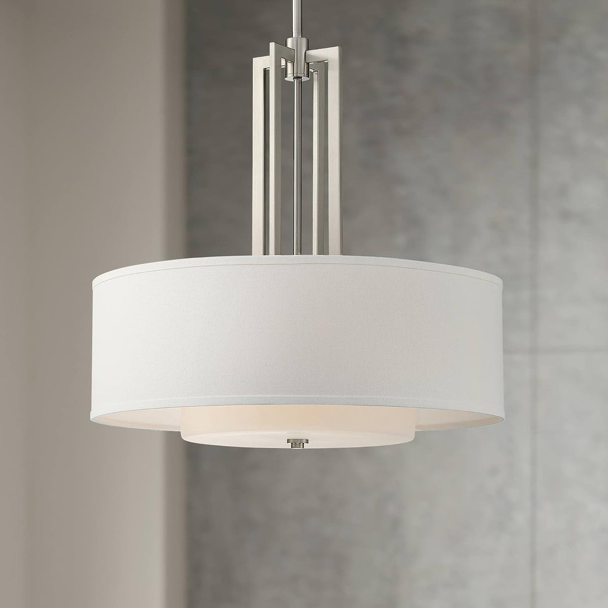 Close interior shot of the nickel-finish pendant hanging against a soft gray textured wall