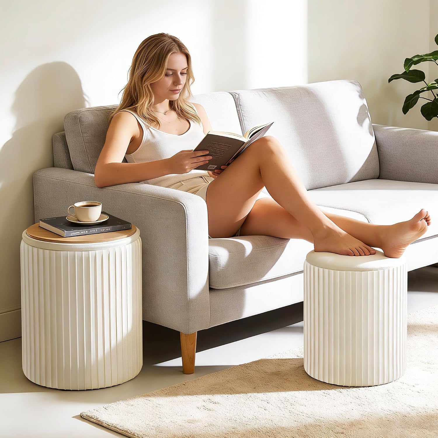 Beige ottoman set used as footrest and side table with a person reclining on a sofa