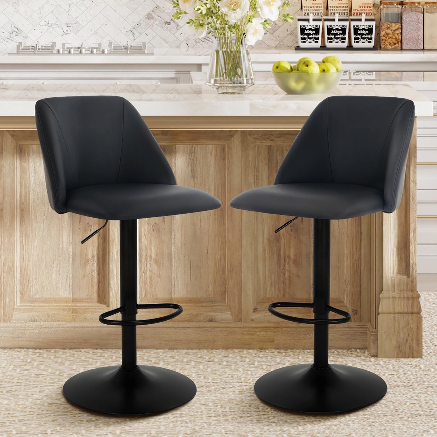 Pair of charcoal fabric swivel bar stools side-by-side at a kitchen island with round black bases