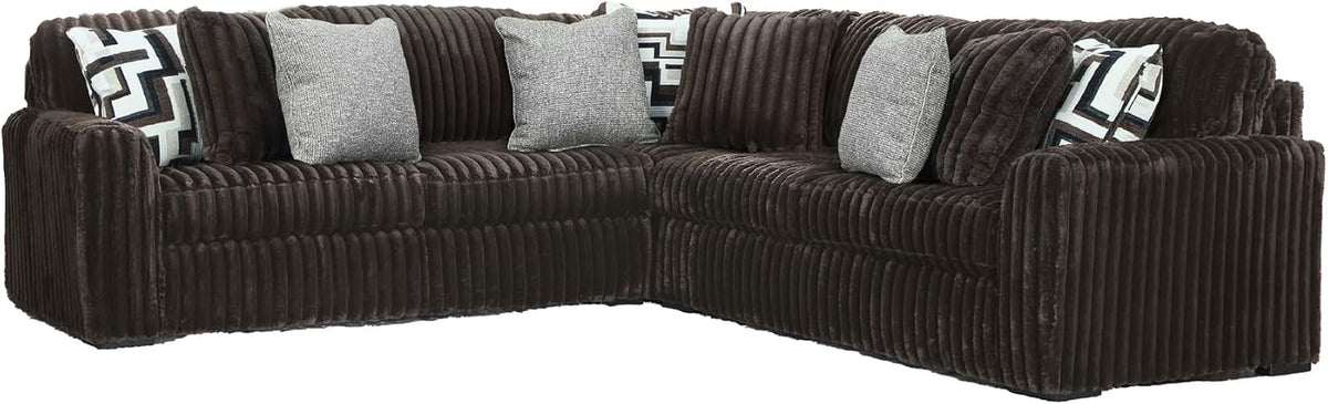 Chocolate-brown corduroy sectional corner piece with multiple gray and patterned throw pillows