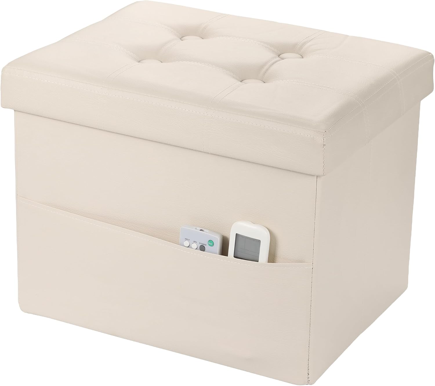 Cream faux-leather storage ottoman with tufted top and front pocket holding two small electronic remotes