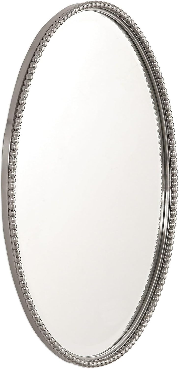 Angled side view showing the depth and beaded metal frame of the oval mirror