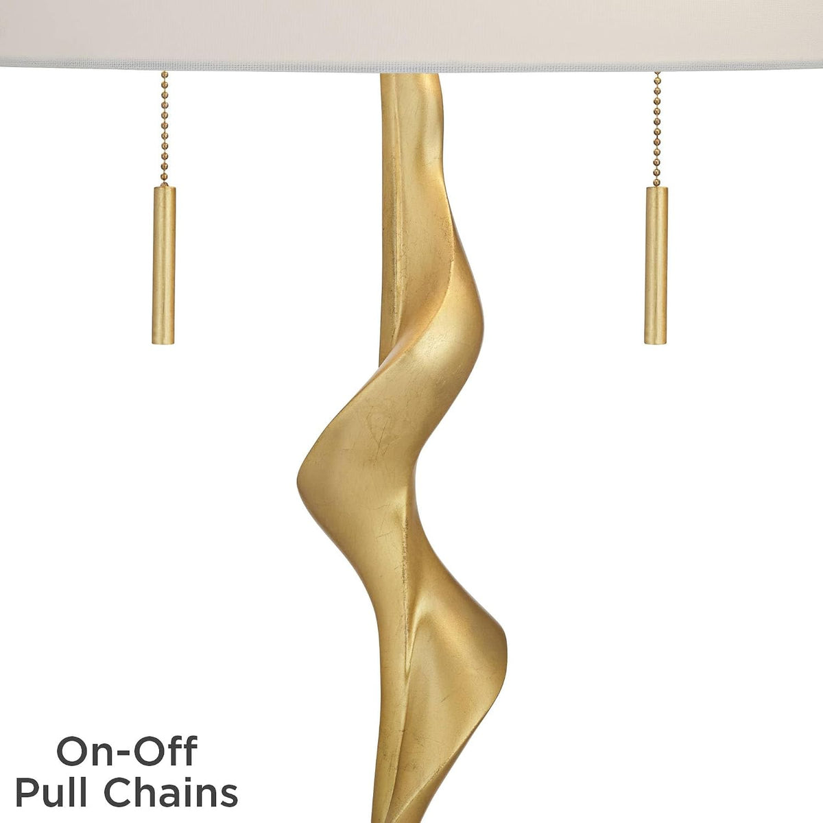 Detail view of the twin gold pull chains and the gold sculptural column beneath the shade
