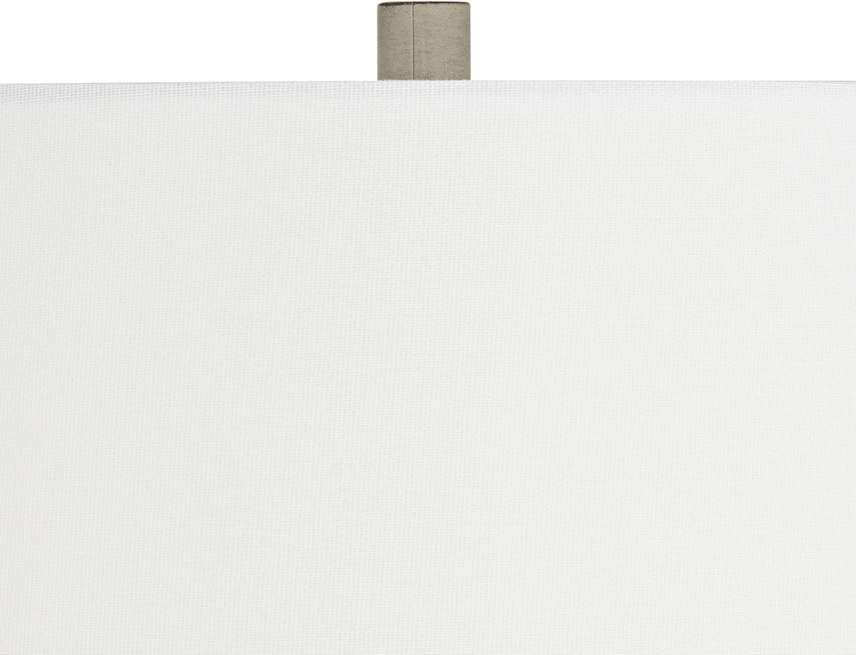 Close-up of the white fabric drum shade texture and top finial