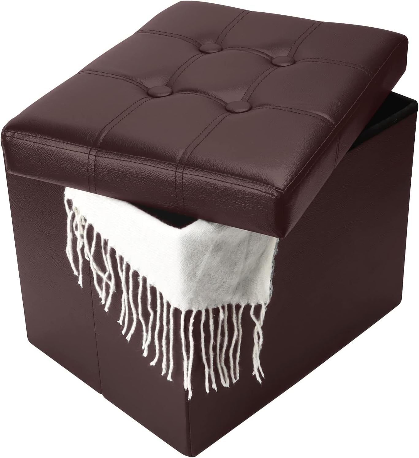 Brown tufted ottoman with the lid partly open and a white fringed throw draped from the interior.