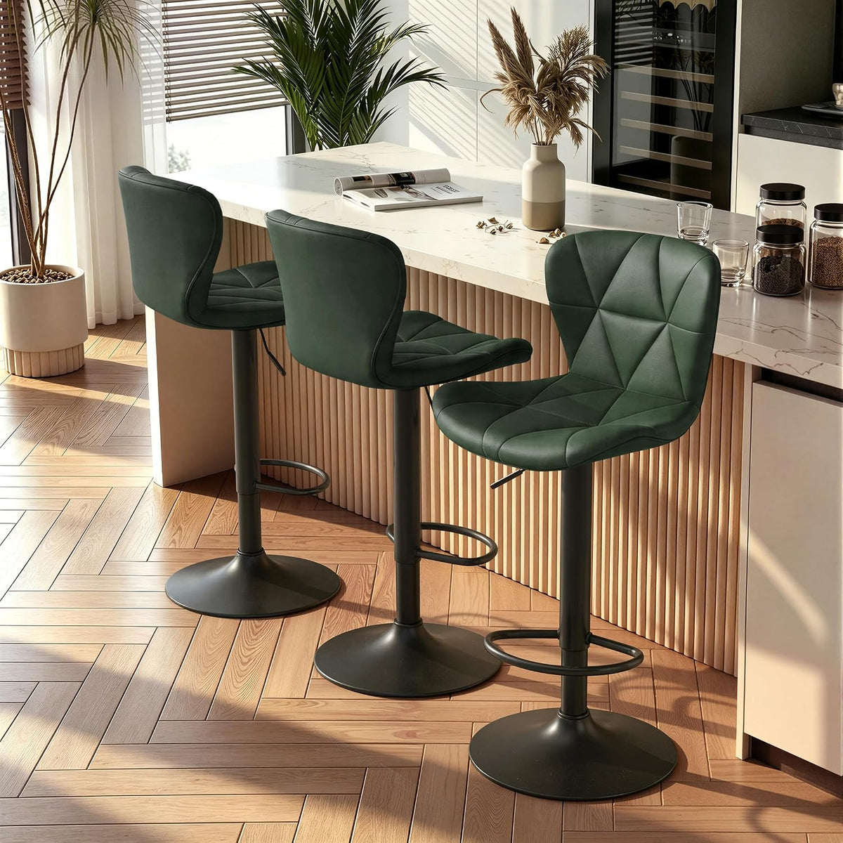 Three dark green swivel stools lined along a fluted-front counter with sunlight and plants nearby.