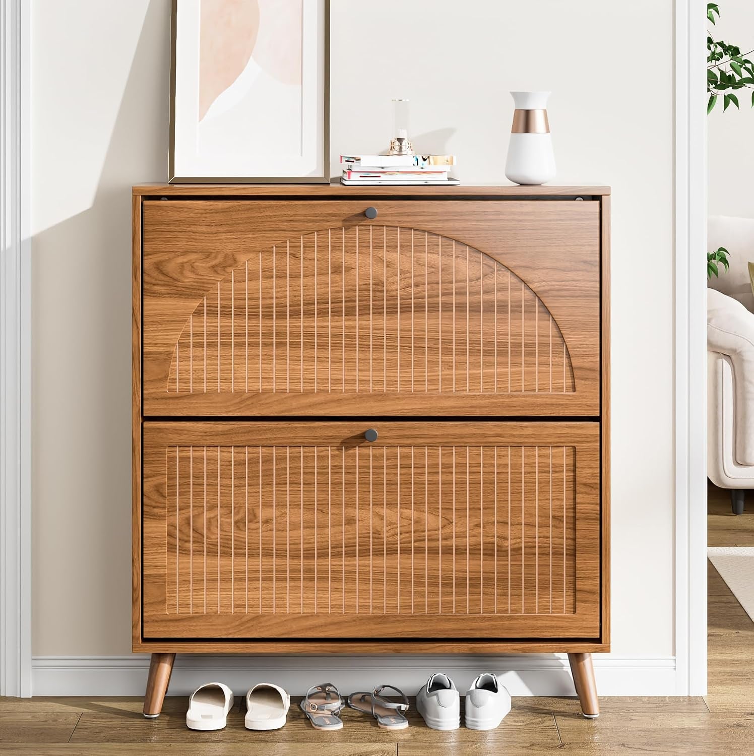 Walnut-finish two-drawer shoe cabinet with arched fluted fronts and tapered legs, shoes lined below