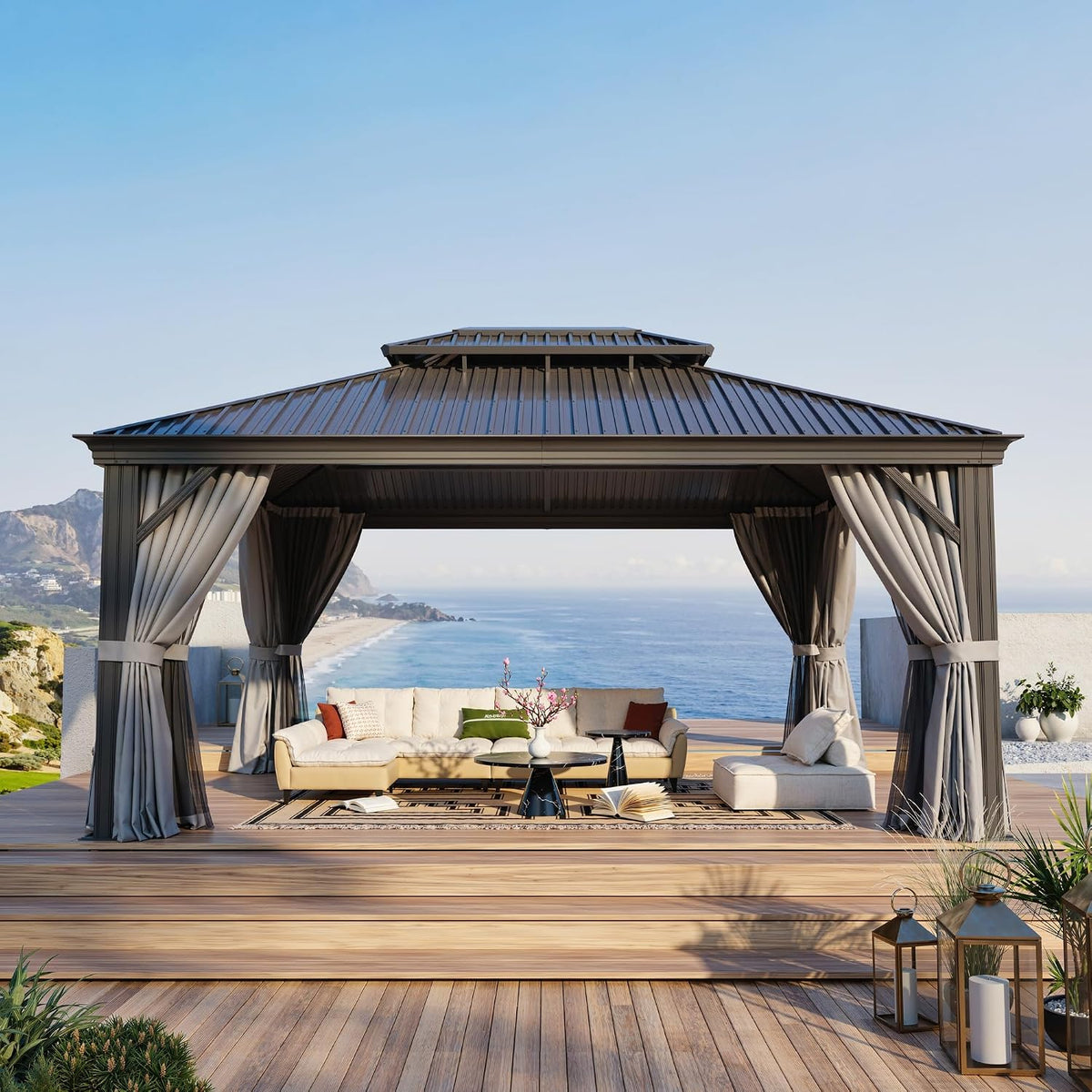 Front view of gray hardtop gazebo on wooden deck with sofa and ocean view in the background