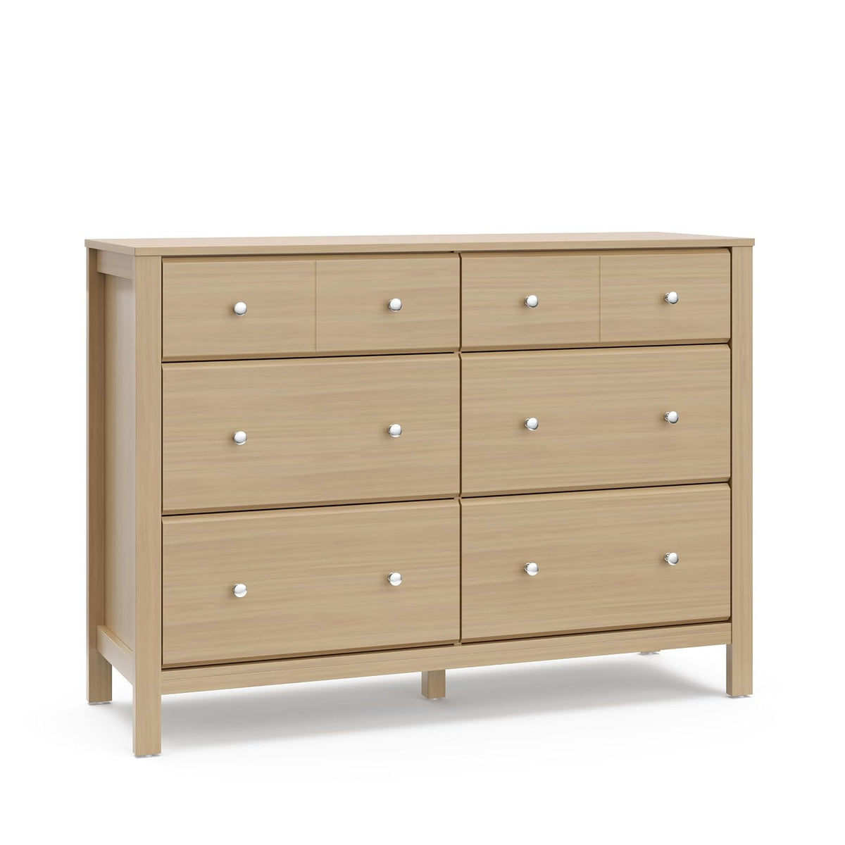 Close-up front view of light wood finish dresser showing upper drawers and round metal knobs