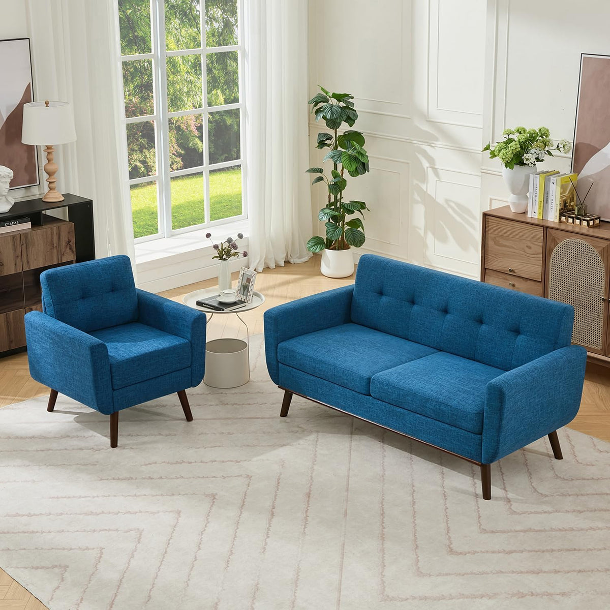 Blue upholstered armchair next to matching three-seat sofa in sunlit room