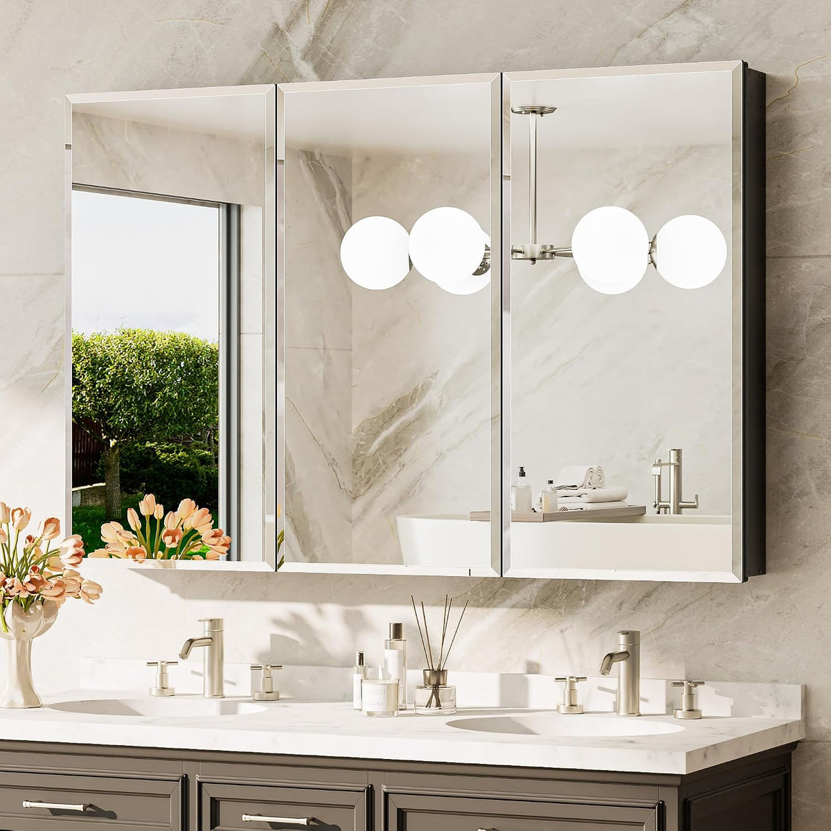 Three mirrored cabinet doors mounted above a double-sink vanity with floral arrangement.