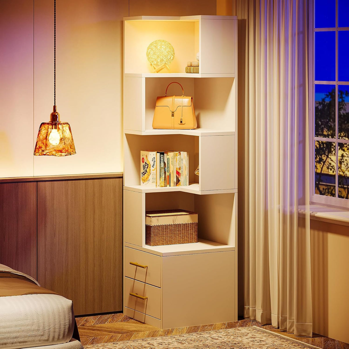 Warmly lit white corner bookcase styled with books and décor