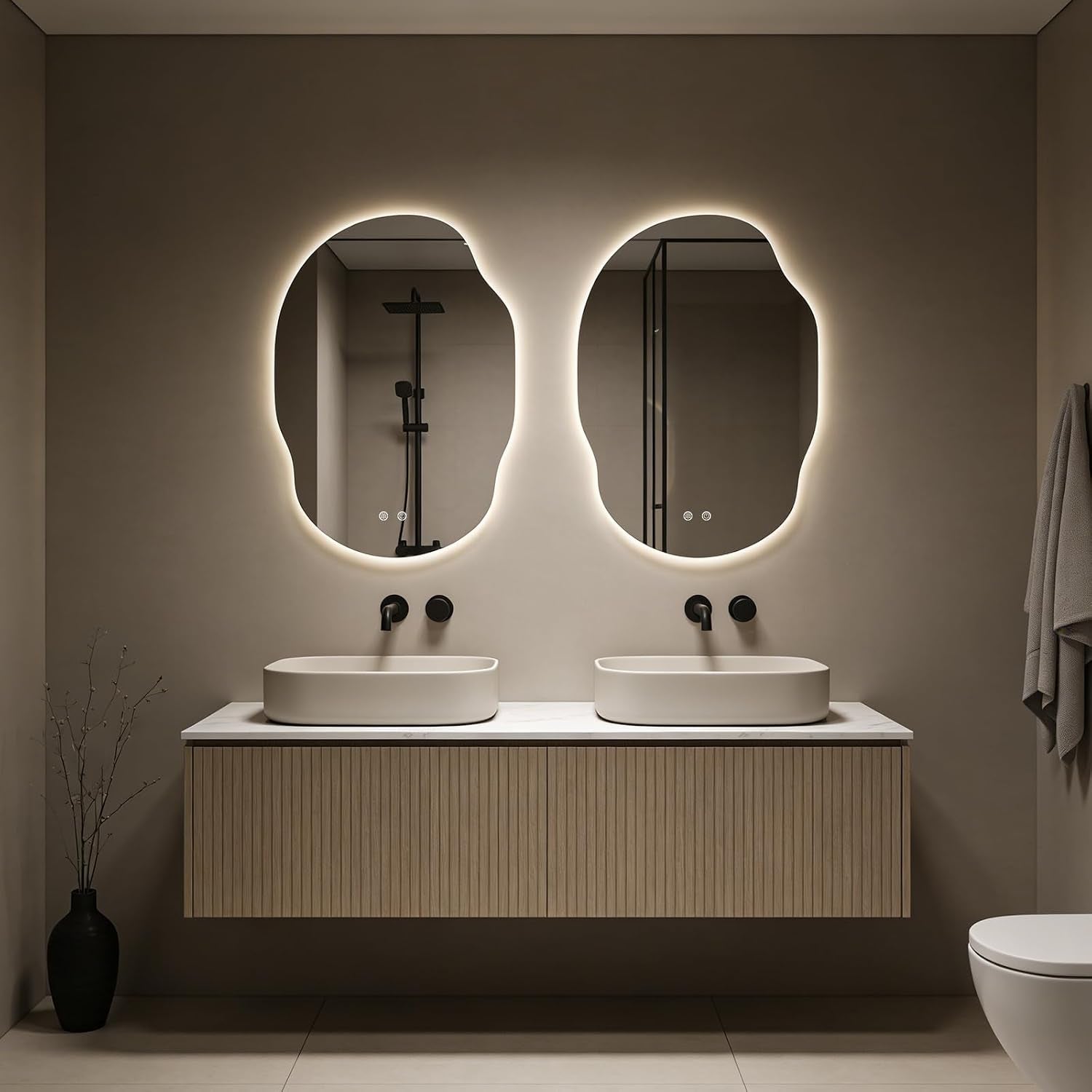 Two matching organic LED backlit mirrors installed above a double vanity in a neutral-toned bathroom