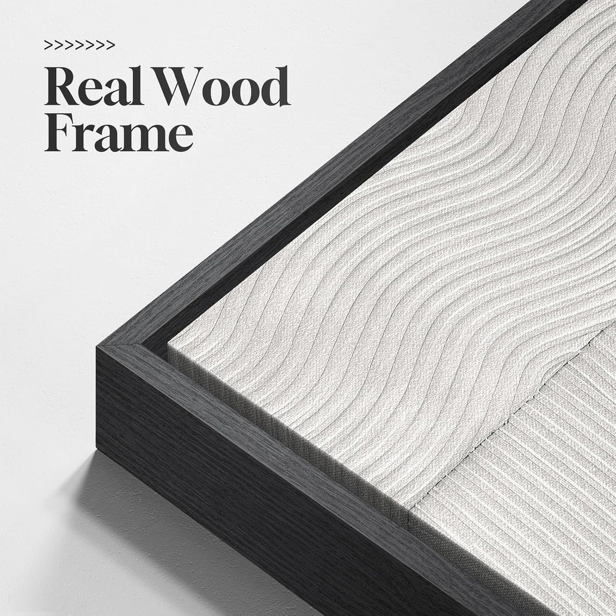Close-up of a black solid wood frame corner and flat printed canvas surface showing texture and a mitred joint