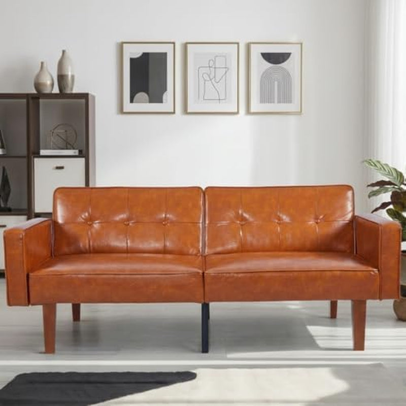 Front-facing shot of a cognac brown tufted convertible sofa with wooden legs in a living room.