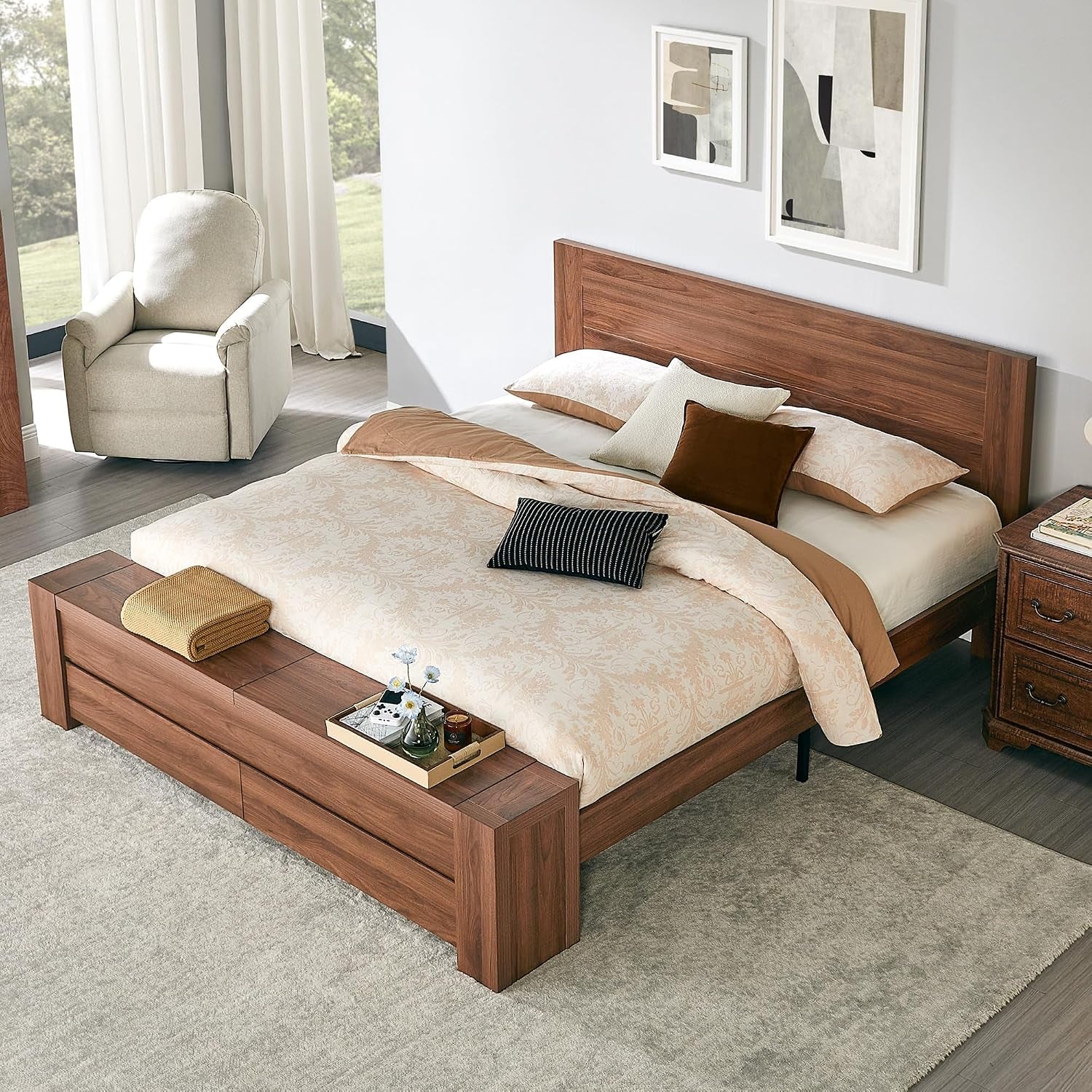 Warm medium-dark wood platform bed with low headboard and integrated storage bench at the foot.