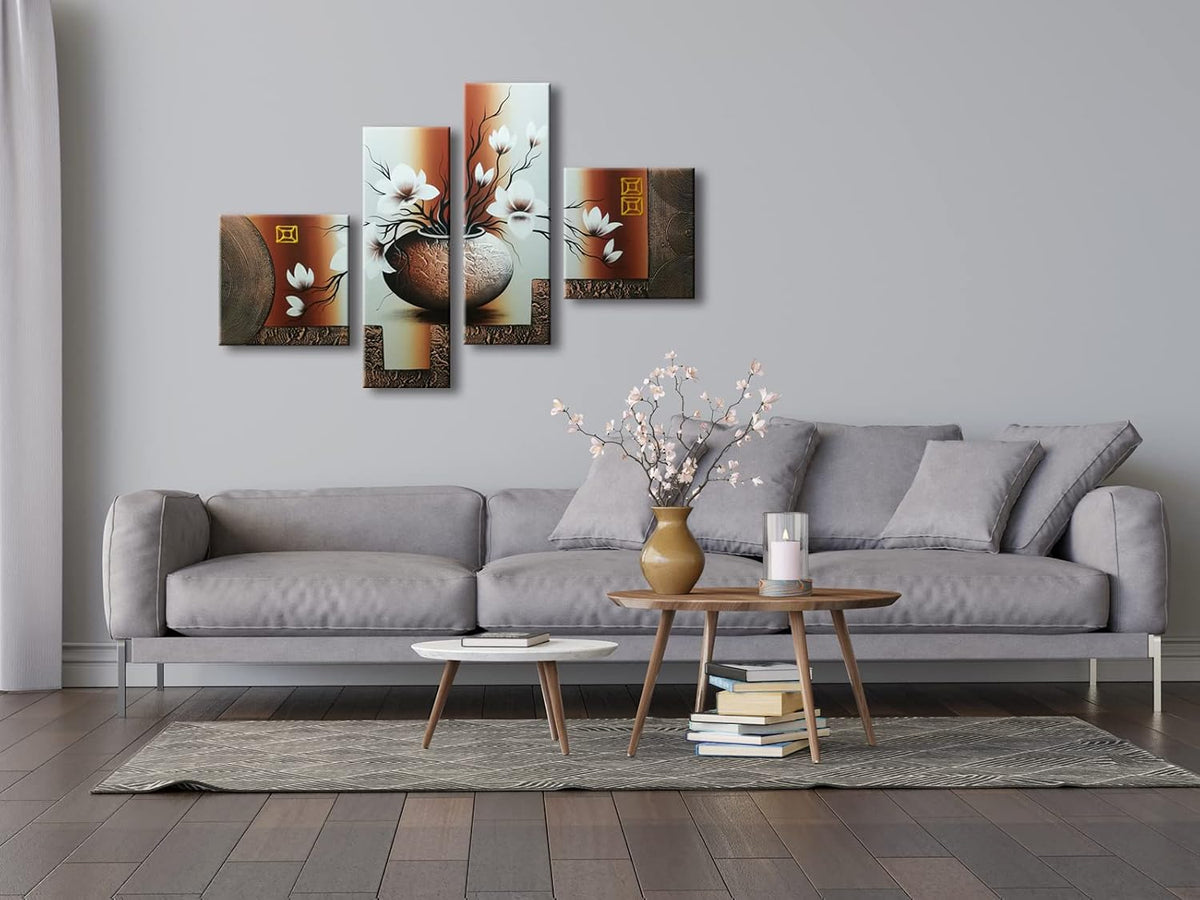 Four-panel floral canvas hung above a grey sofa in a modern living room staging with coffee table and rug.