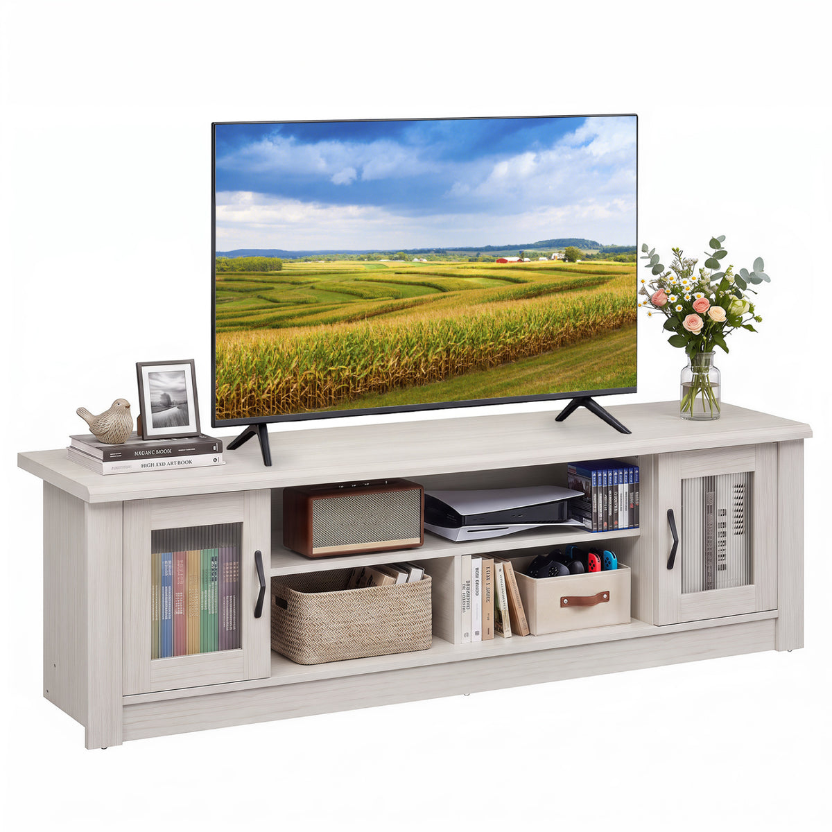 Light wood TV stand arranged with books and baskets beneath a television, with flowers and a framed photo on top.