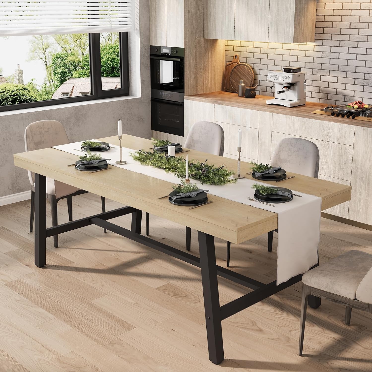 Dining table with light blond wood top and black metal legs dressed with a white table runner and plates.