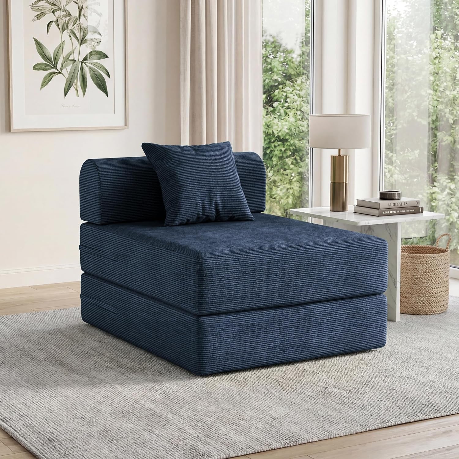 Single navy corduroy folding sofa chair with back pillow in a bright living room