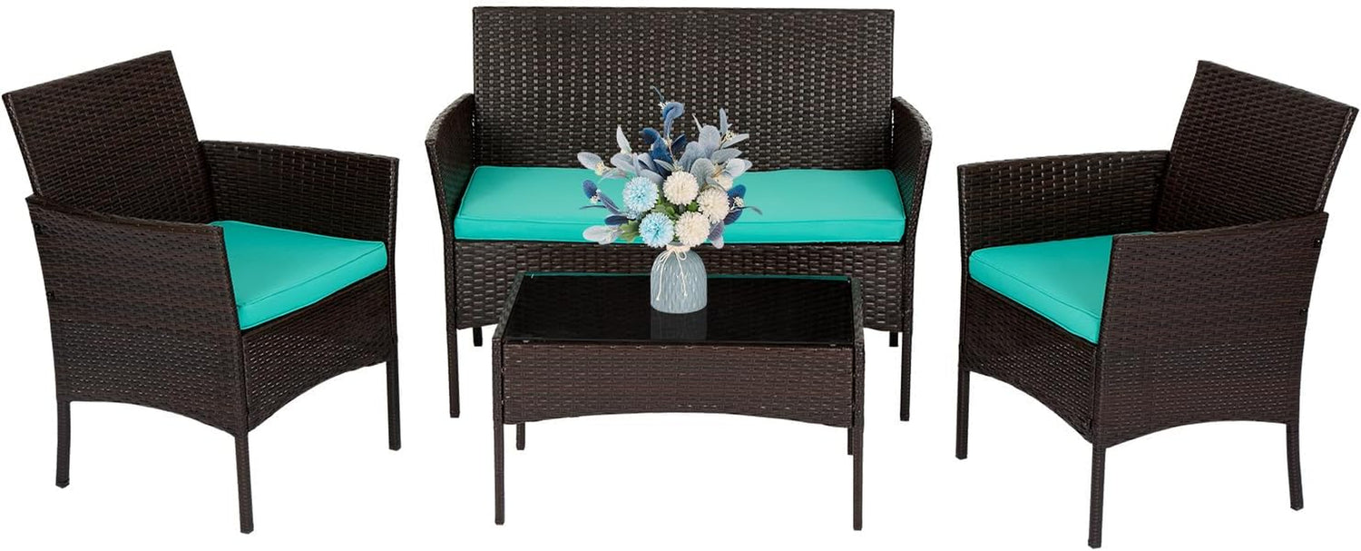Four-piece dark brown rattan set with turquoise seat cushions and glass-top coffee table with vase