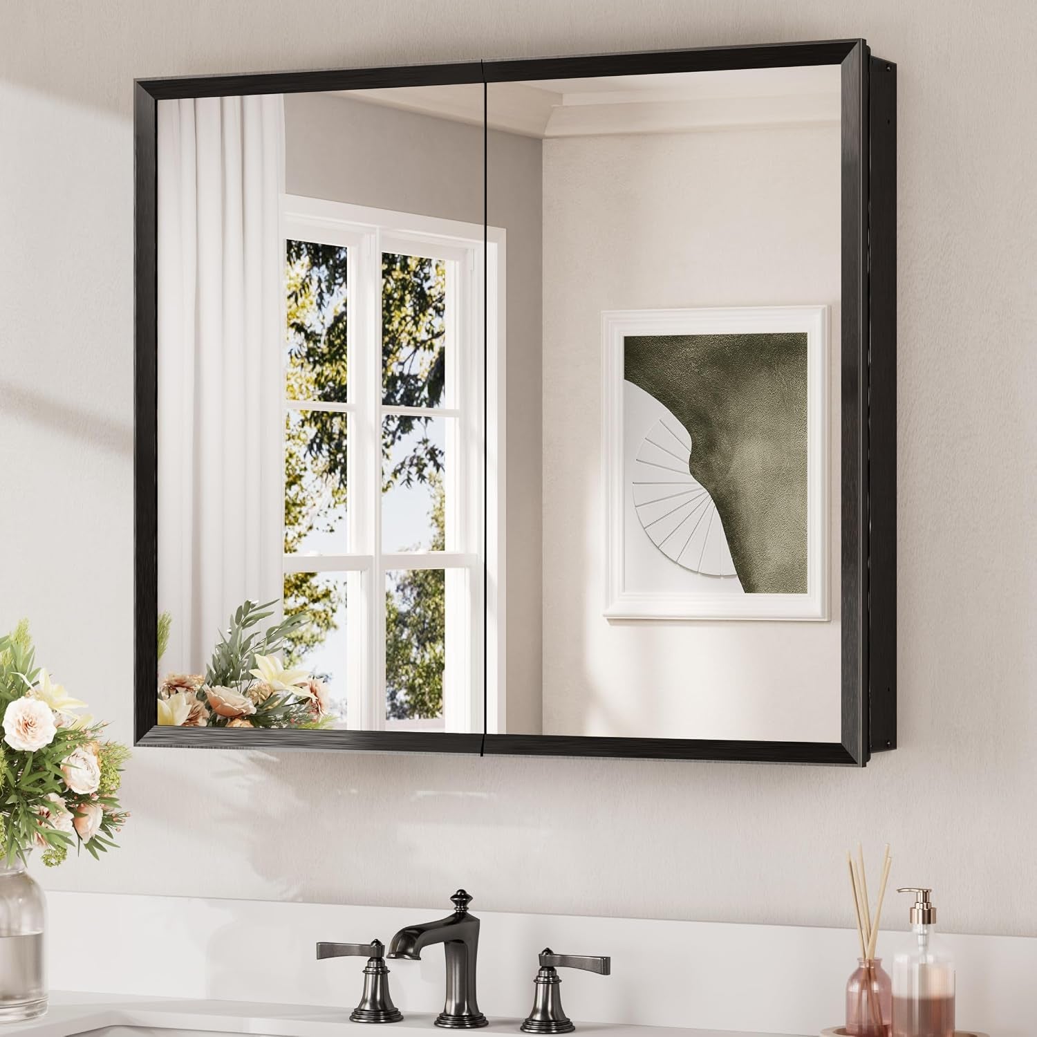 Wall-mounted mirrored medicine cabinet with black frame and two mirrored doors above a sink.