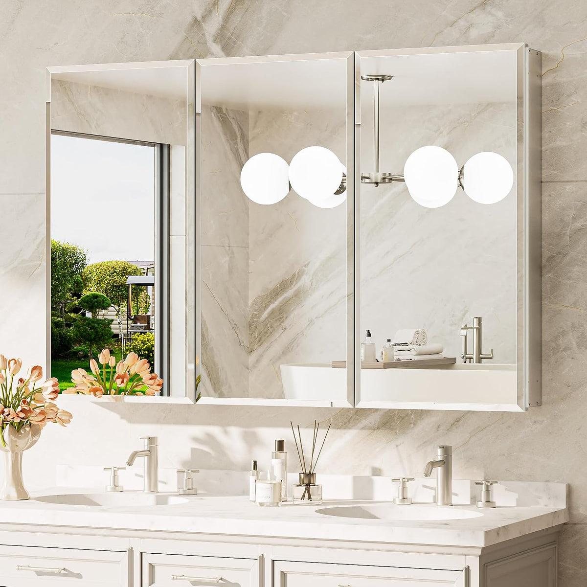 Three-door mirrored cabinets angled slightly to show reflective fronts and side panels over vanity